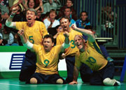 The Australia Men's Volleyball team celebrate during the Australia v Libyan Arab Jamahiriya Sitting Volleyball match during the 2000 Paralympic Games  Scott Barbour/Allsport