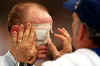 Picture of a referee inspecting the eye-shades of an athlete before the beginning of a game.  Allsport