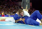 Picture of judokas competing. Hold-down technique. Photograph  Bob Willingham, IJF Photographer