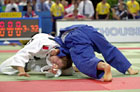 Picture of judokas competing. Strangling technique. Photograph  Bob Willingham, IJF Photographer