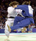 Picture of women judokas competing. Leg technique. Photograph  Bob Willingham, IJF Photographer