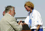 The 21st Athens Classic Marathon took place in the framework of Athens 2003 Sport Events. In the photograph, the ATHENS 2004 Executive Director Marton Simitsek awards the cup to Georgia Ampatzidou, the first Greek woman athlete who came 2nd in the Women General Ranking.  ATHOC / PHOTO: A.N.A /  Α. VLACHOS