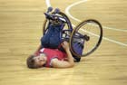 Photo of Paralympic baskeball athlete lying on his back on baskeball court